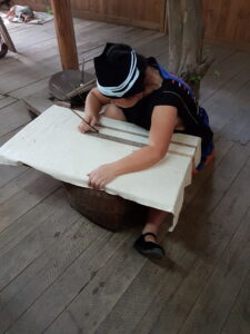 A Yao woman painting a cloth.
