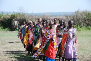 A Group of Maasai Women in Traditional Clothing Standing in a Field